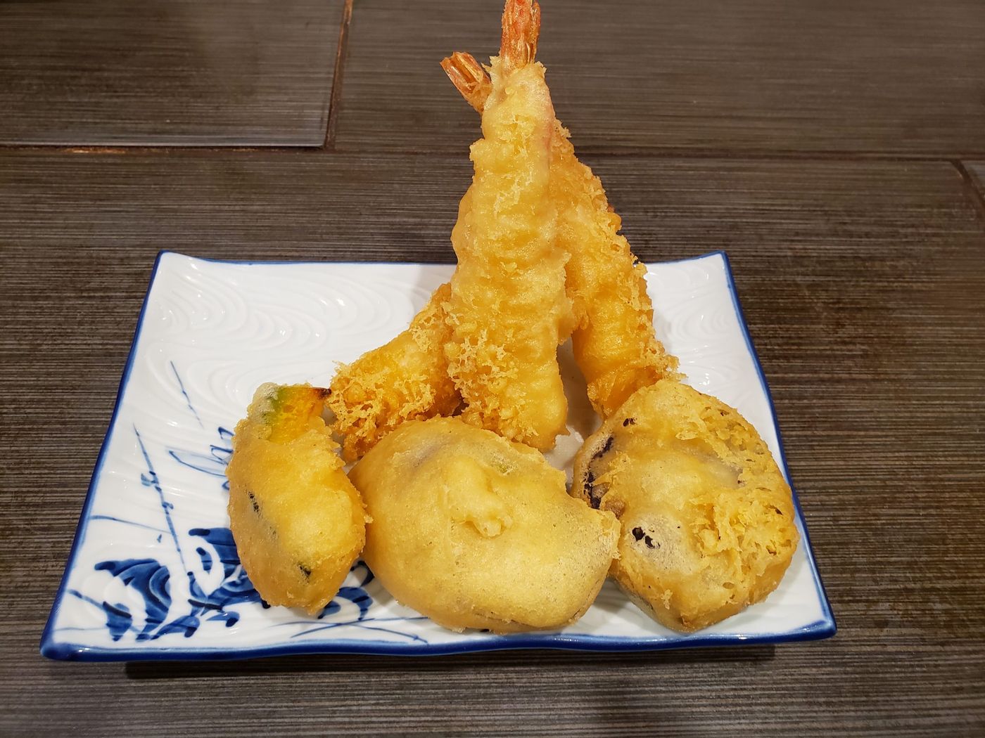 Shrimp and vegetable tempura on a blue and white plate